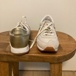 New Balance gold and white sneakers